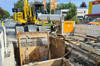 Sewer construction site with excavator